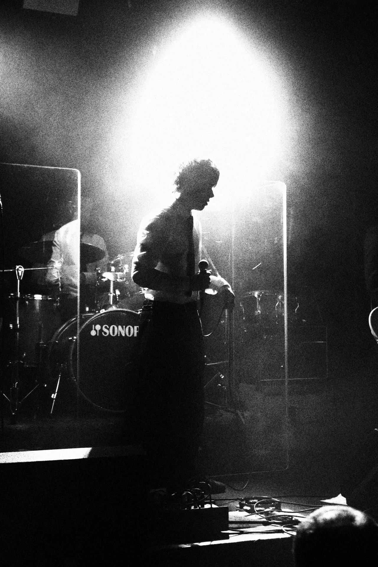 Kemlo silhouetted against a white backlight on stage